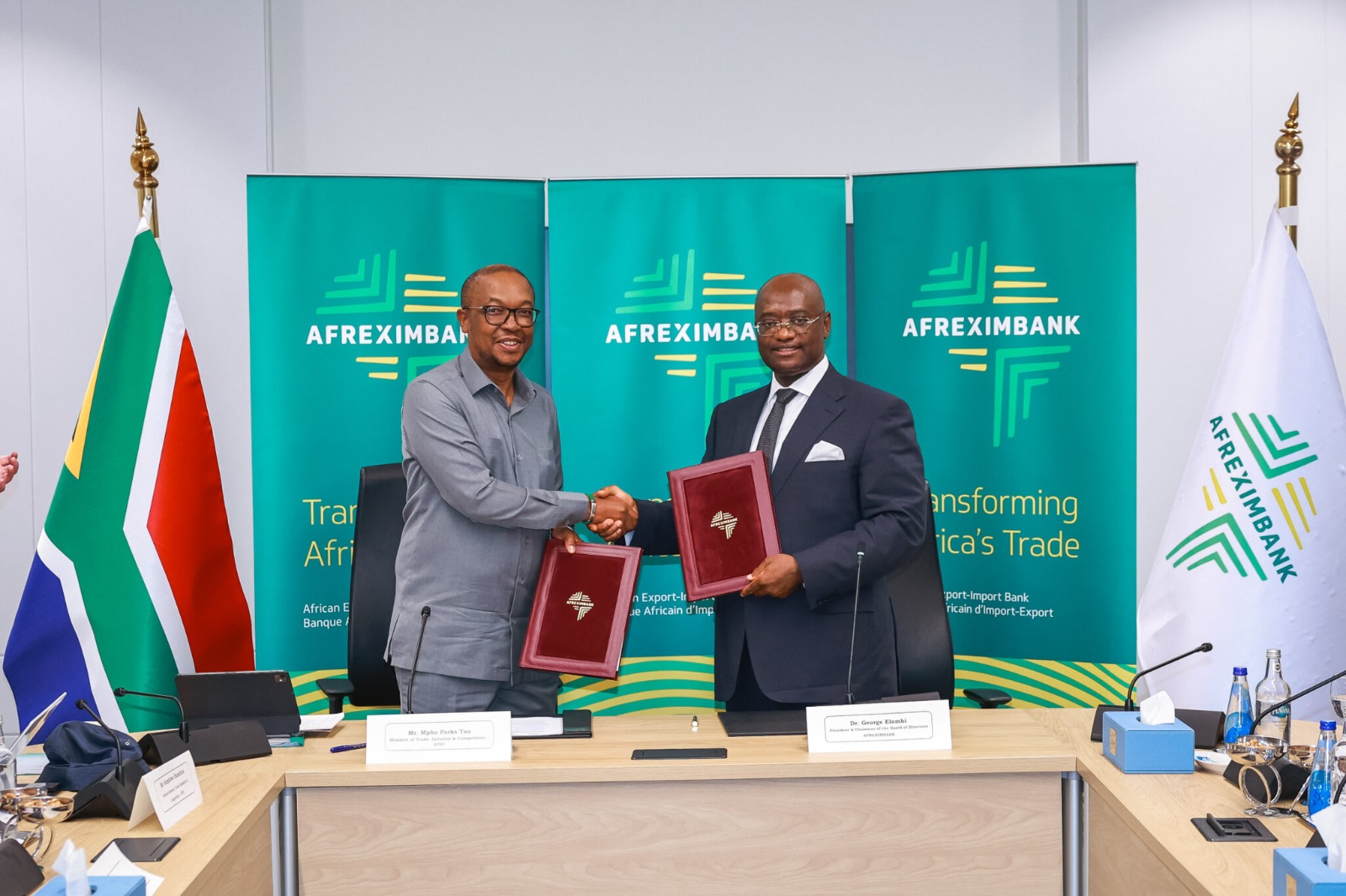 Minister Parks Tau and Dr George Elombi shaking hands after signing the US$14 billion Country Programme against Afreximbank branding